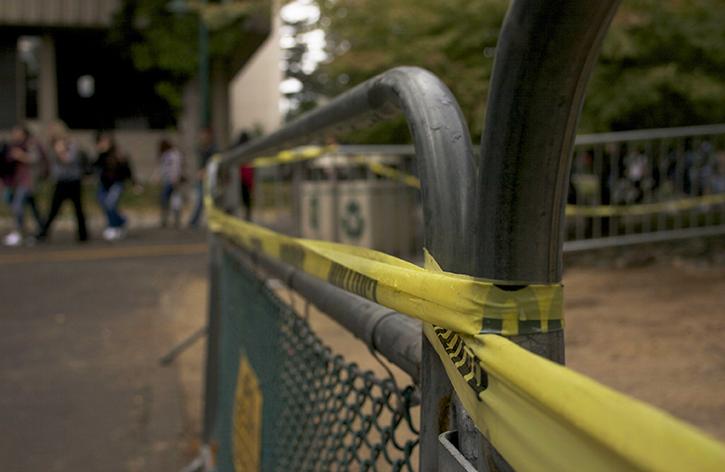 A metal fence cordons off an area south of Santa Clara Hall that initially contained asphalt contaminated with dangerous amounts of lead. The asphalt was removed Saturday and the barrier is expected to come down this week, according to Daryn Ockey, the director of facility operations for Sacramento State. (Photo by John Ferrannini)