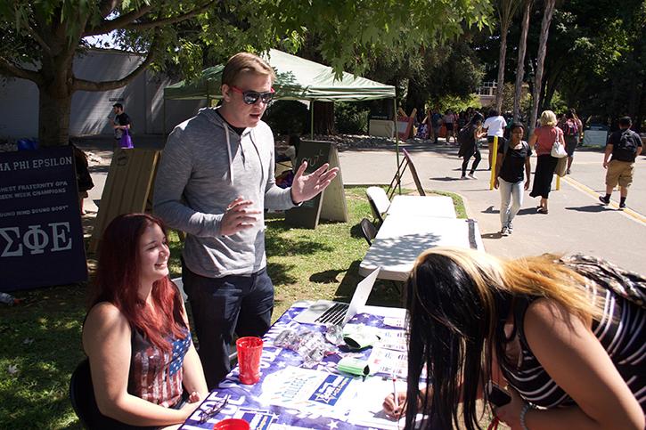 Former Sacramento State College Republicans chairman Ryan Brown, center, speaks with freshman Jazmine Teodechi on Wednesday, September 7, 2016 as she signs up to receive emails from the club as College Republicans executive director Angela Wold laughs at a joke. Brown is the Republican candidate for California State Assembly District 7, challenging incumbent Democrat Kevin McCarty. (Photo John Ferrannini)
