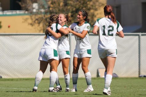 Junior forward Andrea Boehm celebrates with her teammates after her goal against Saint Mary's at Hornet Field on Sept. 18, 2016. (Photo by Matthew Dyer)
