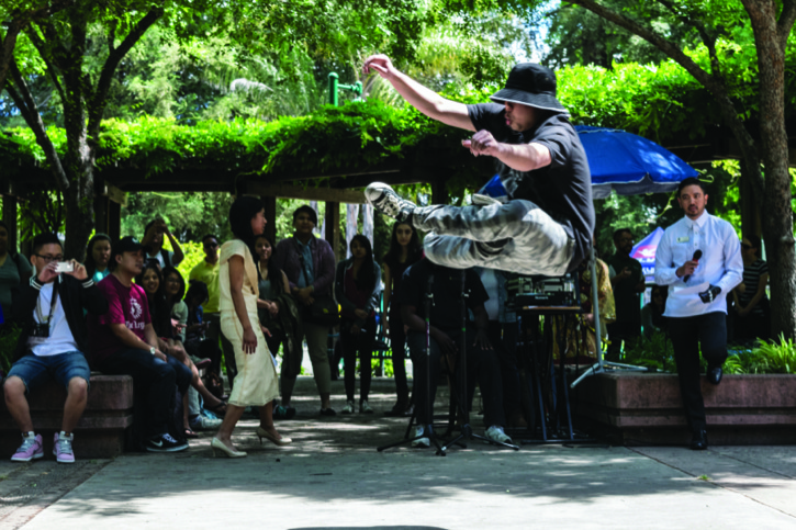 John Cao, senior communication studies major, break dances during the Asian Pacific Islander Fest Day on Wednesday, April 27 in the Library Quad.