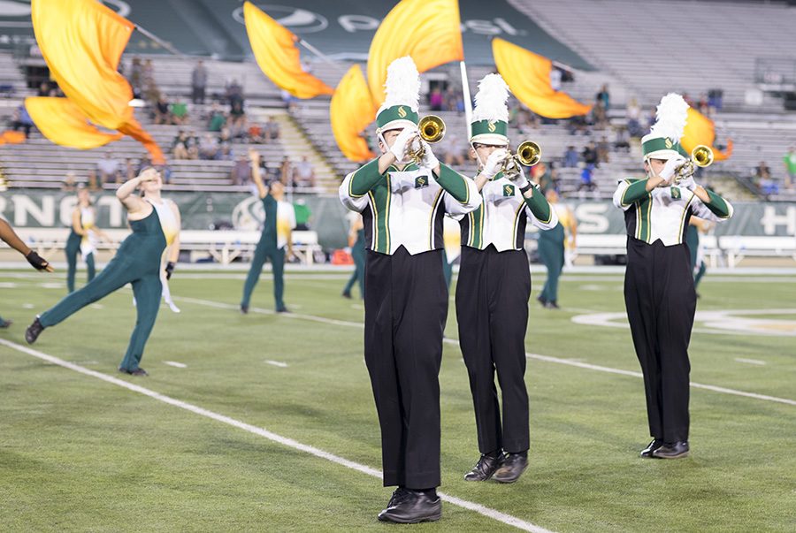 Sacramento State marching band trumpeters and color guard members perform at halftime during the homecoming football game at Hornet Stadium on Saturday, Oct. 8. A crowd of 9,614 people were in attendance.