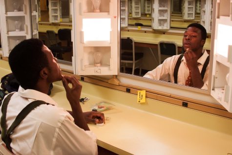 Hickman puts on makeup during rehearsal for 'The Diviners.' (Photo by Jessica Wilson)