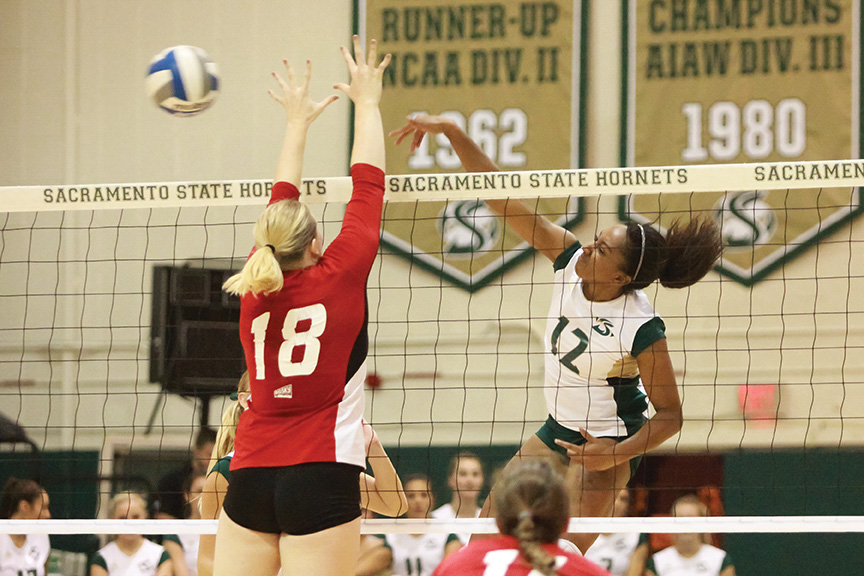 Sacramento State sophomore middle blocker Brie Gathright spikes the ball past Kimberly Brinkworth of Eastern Washington at the Hornets Nest on Saturday, Oct. 22. (Photo by Matthew Dyer)