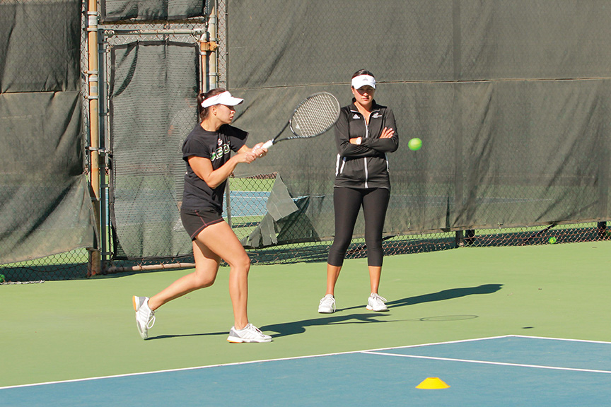 Sacramento State women’s tennis coach Clarisse Baca watches senior Alina Soltanici practice her backhand at the tennis courts on campus. Soltanici has been ineligible to compete for the last eight months due to an ongoing investigation. (Photo by Matthew Dyer)