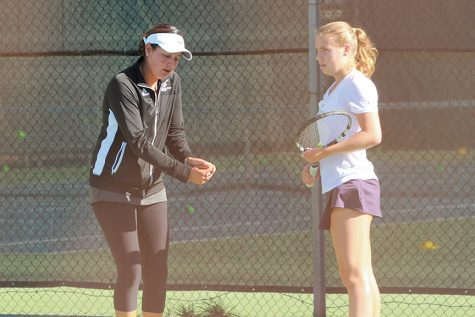 Sacramento State women's coach Clarisse Baca shows freshman Louisa Brunetti a technique to improve her backhand swing during practice at the Sac State tennis court. (Photo by Matthew Dyer)