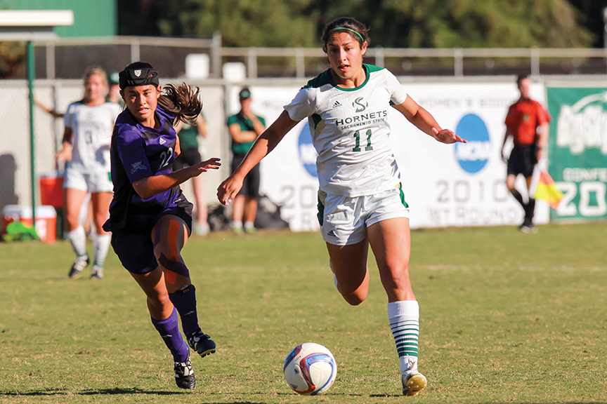 Sacramento State senior midfielder Jennifer Lum dribbles the ball past Amy Chidester of Weber State at Hornet Field on Friday, Oct. 21. (Photo by Matthew Dyer)