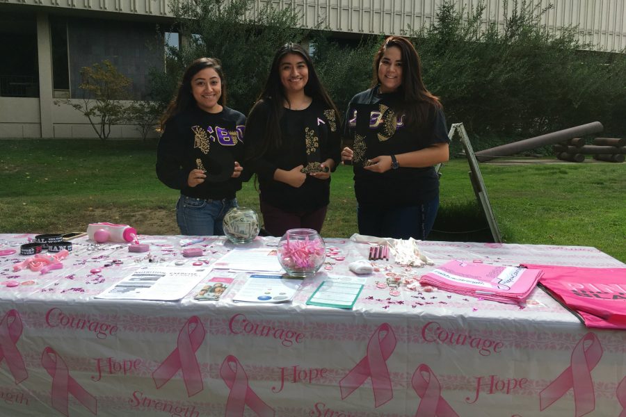 Sisters+of+Sigma+Theta+Psi+stand+behind+a+table+to+fundraise+for+breast+cancer+awareness+outside+the+LIbrary+on+Oct.+13.%0A%28Photo+by+Brian+Ingebretsen%29