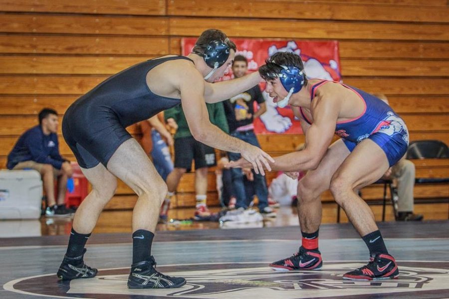 Sacramento State senior Tony Delgado prepares to grapple against a Fresno State opponent in his first season with the wrestling club. Delgado qualified for nationals after placing third in the 165-pound weight class at the West Coast conference tournament. (Photo courtesy of Tony Delgado)