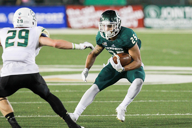 Sacramento State senior running back Jordan Robinson jukes a Cal Poly defender on Saturday at Hornet Stadium, Robinson led the Hornets in rushing with 117 yards and two touchdowns. (Photo by Francisco Medina)