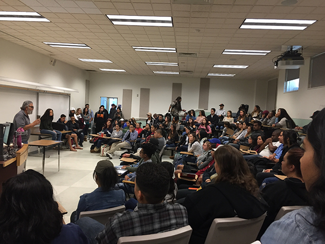 Left, criminal justice professor speaks  about his comments while fellow criminal justice professor Julie Mumma, center, listens and waits to speak. (Photo by Oleg Istratiy)