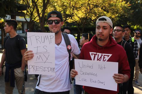 A handful of Trump supporters came to the protest with their own signs showing support for the president-elect and sparking a verbal confrontation with Trump protesters. (Photo by Kameron Schmid)