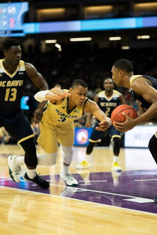 Sacramento State junior forward Justin Strings attempts to steal the ball away from Brynton Lemar of UC Davis at Golden 1 Center on Monday, Nov. 21. (Photo by Michael Zhang)