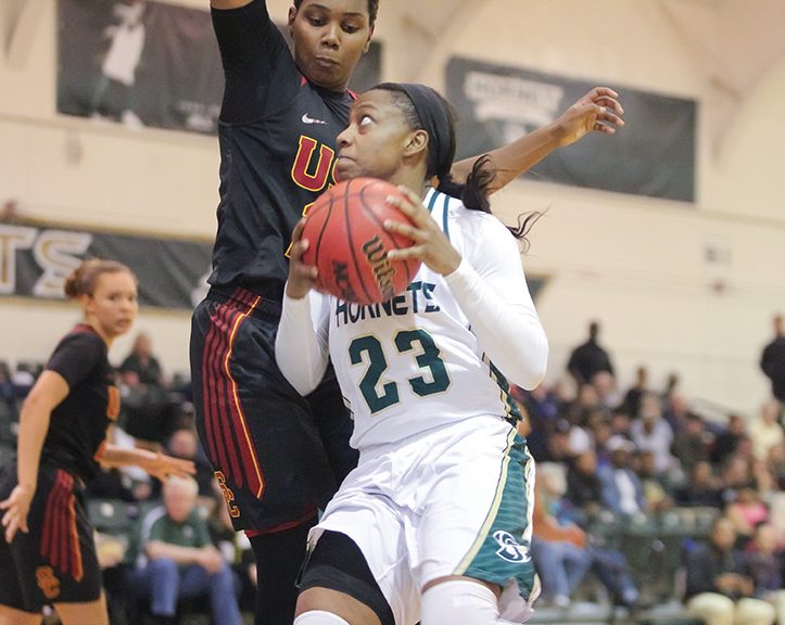 Sacramento State junior guard Dajhae Mullins drives to the basket for a layup against a USC defender at the Nest on Saturday, Dec. 3. (Photo by Matthew Dyer)