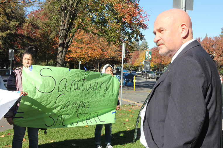 Sacramento State President Robert Nelsen, right, meets with protesters outside of his Sacramento Hall office on Thursday, Dec. 1 who want the campus declared a ‘sanctuary’ for undocumented students. (Photo by Rin Carbin)