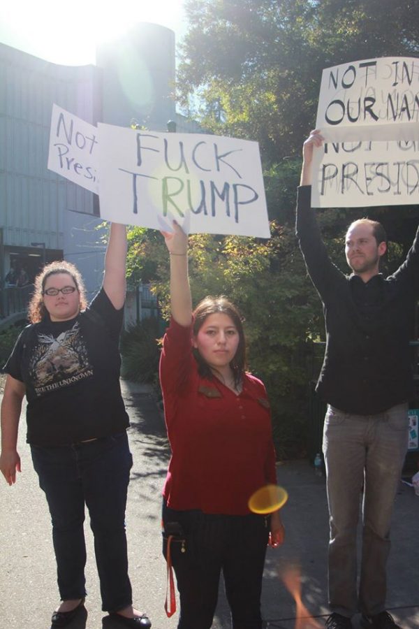 Students brandish anti-Donald Trump signs during the campus protest the day after Trump was elected president. (Photo by Barbara Harvey)