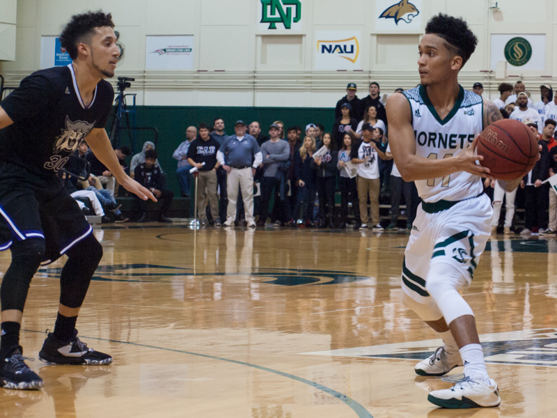 Sacramento State senior guard Trevis Jackson looks for an open teammate against Weber State at the Nest on Feb. 9. (Photo by Andro Palting)