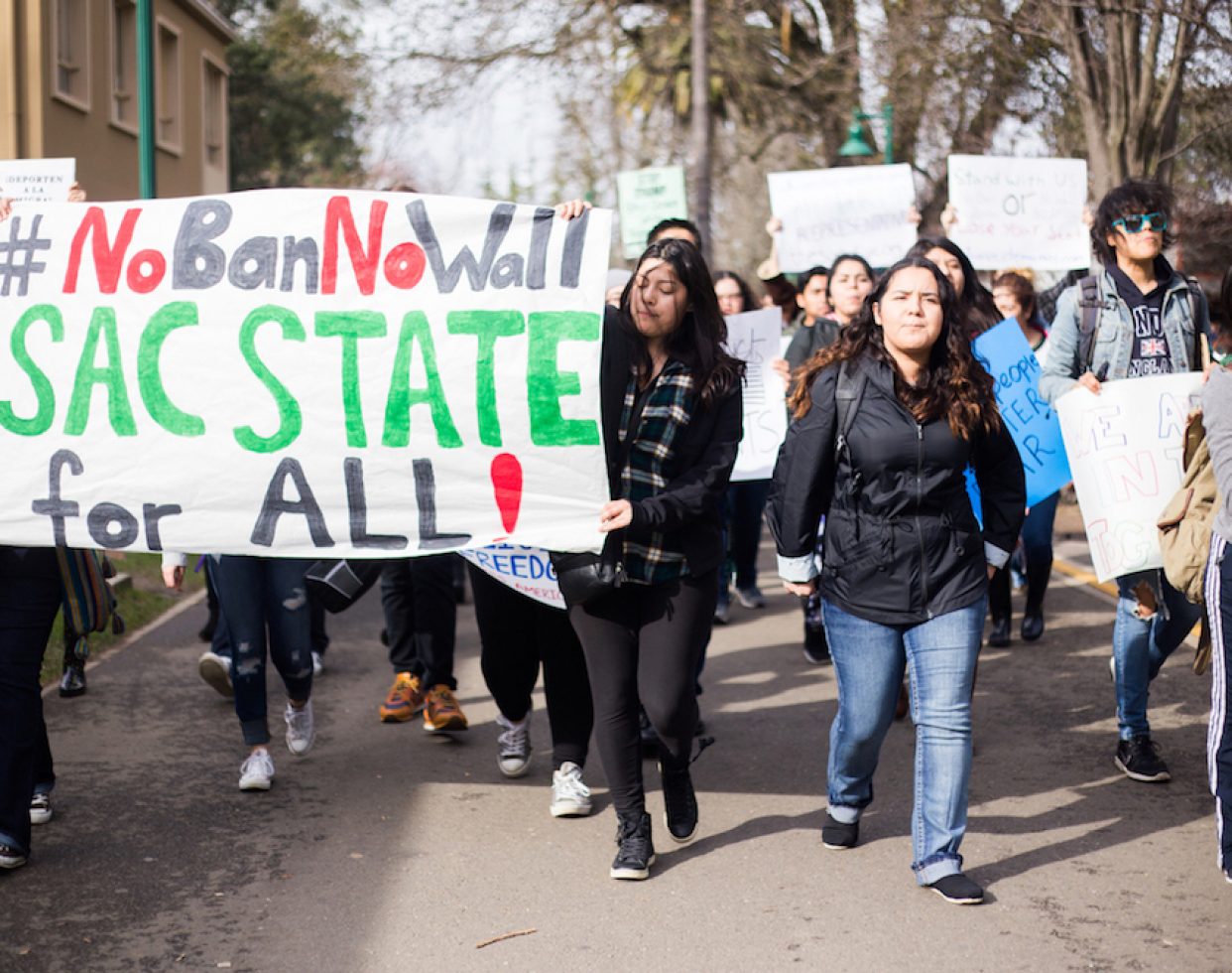 Demonstrators march through the Sacramento State campus during a #NoBanNoWall protest on Feb. 2, 2017. An estimated 300 people attended.