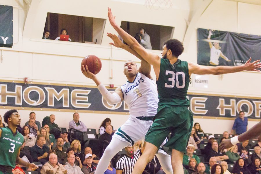 Sacramento State junior forward Justin Strings shoots the ball past Traylin Farris of Portland State at the Nest on Jan. 28.  Strings had 11 points and three rebounds for Sac State in a 80-77 victory. (Photo by Matthew Dyer)