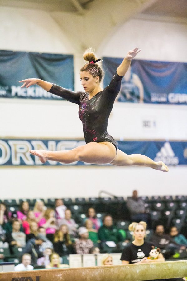 Sacramento State senior gymnast Julia Konner leaps during her beam routine against Alaska Anchorage at the Nest on Feb. 3. (Photo by Nicole Fowler)