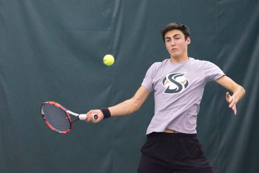 Sacramento State freshman Louis Chabut forehands the ball against Travis Lau of North Dakota at Spare Time Indoor Tennis Center on Friday. (Photo by Matthew Dyer)