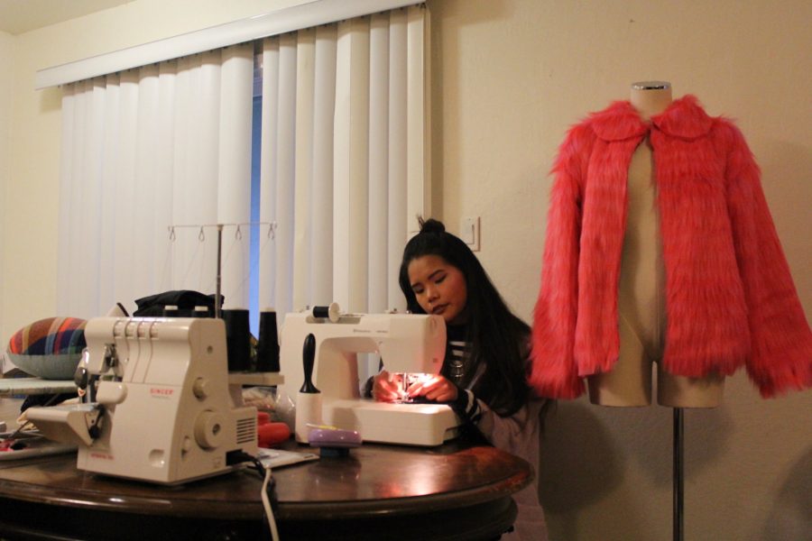 Sacramento State alumna Theresa Truong designs clothes for Sacramento Fashion Week at her home studio. On the mannequin at her side stands The Cait Jacket, a faux fur piece she crafted after feeling the need to make something pink and furry. (Photo by Sharlene Phou)