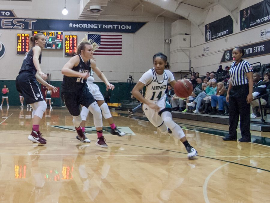 Sacramento State freshman guard Quayonna Harris dribbles the ball against Montana at the Nest on Feb. 16. (Photo by Andro Palting)