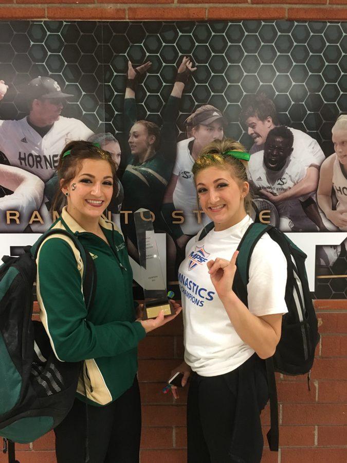 Sacramento State junior gymnasts Courtney and Caitlin Soliwoda show off the trophy after helping the Hornets win the Mountain Pacific Sports Federation Conference championship in 2016. (Photo courtesy of Courtney Soliwoda)