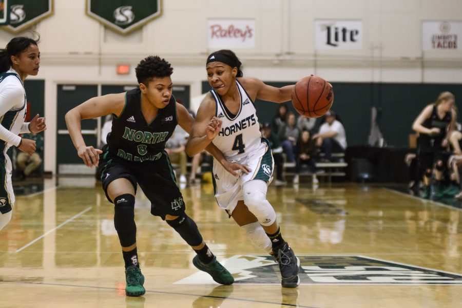 Sacramento State guard Justyce Dawson drives past University of North Dakota guard Chastity Franklin for a basket at the Nest on Wednesday, March 1, 2017. Dawson is one of three seniors on the 2017-18 women’s basketball team, who recently hit the game-winning layup in a 79-77 victory over Southern Utah on Saturday, Feb. 24, 2018.