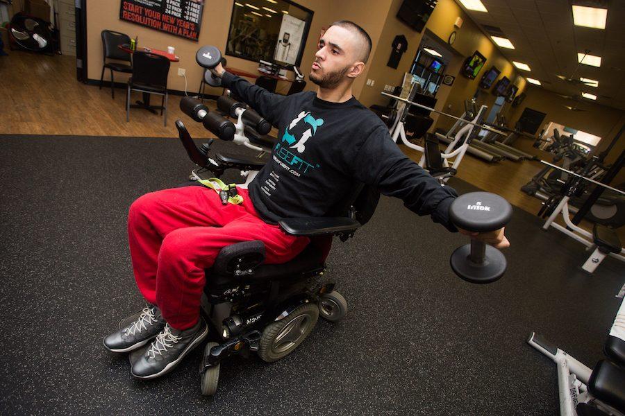 Sacramento State business major Devin Johnson works out during a recent visit to the gym. Johnson is launching FuseFit, an app dedicated to matching trainers with disabled clients. (Photo by Nicole Fowler)
