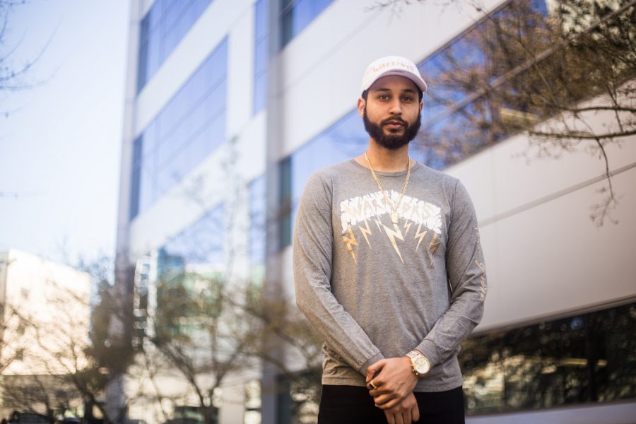 LaSal Garcia, a Sacramento State student and the CEO and founder of Ange Gardien, models a T-shirt and hate from his upcoming fashion line outside of the University Union. (Photo courtesy of LaSal Garcia)