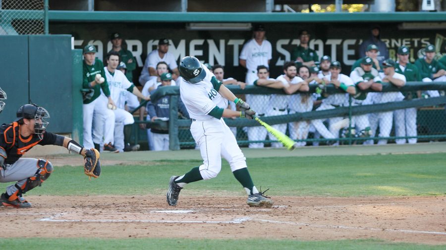 Sacramento State freshman catcher Dawsen Bacho swings and makes contact against the University of the Pacific Tuesday at John Smith Field. (Photo by Max Jacobs)