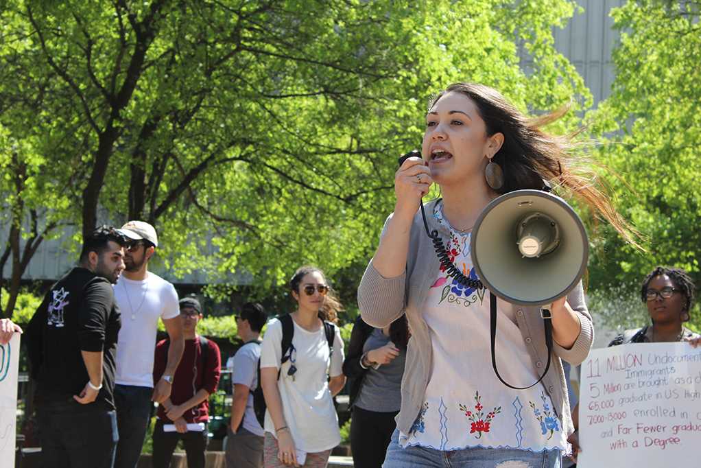 Laura Ramirez, a teaching credential student at Sacramento State, speaks through a megaphone at a protest in the library quad on Thursday, March 30 called A Culture of Love and Hope for All. (Photo by John Ferrannini)
