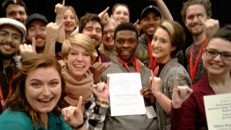 Roderick Hickman, center, and partner Elizabeth Ferreira, center-right, pose with their team after winning first place at the Kennedy Center American College Theater Festival in Denver in February. (Photo courtesy of Michelle Felten / Theater and Dance Department)