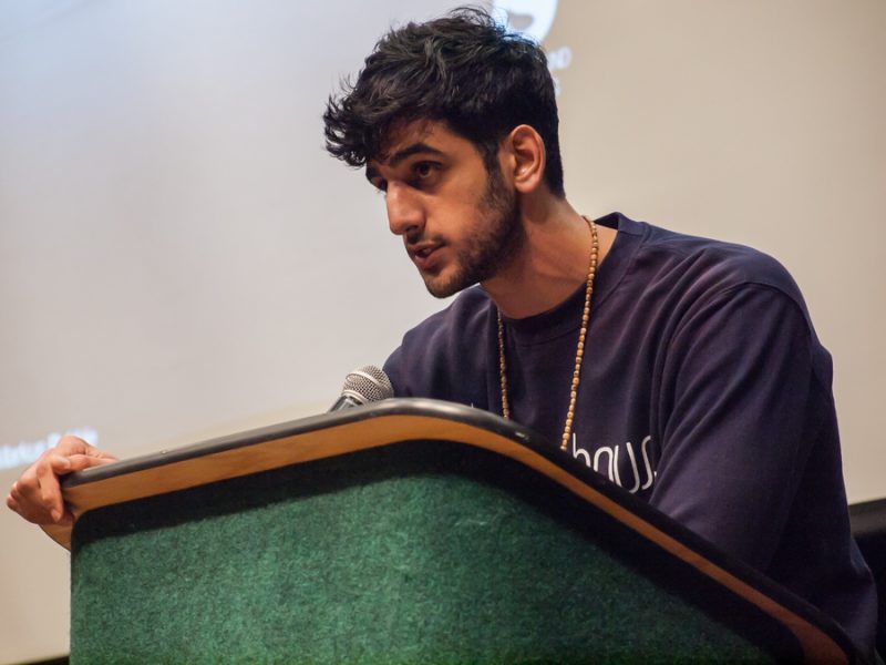 Co-founder of the Peace House Productions Ahmad Hussam reads a poem containining the struggles he has gone through during his time before forming Peace House Productions at the Redwood Room in the Union on April 6. (Photo by Andro Palting)