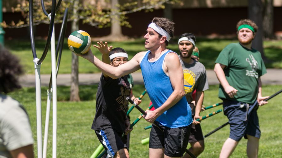 Sacramento State senior Tristan Church scores the quaffle past senior Josue Garcia during practice Friday on the South Green Lawn by The WELL. Each time the quaffle is scored through the rings, it is worth 10 points. (Photo by Matthew Dyer)