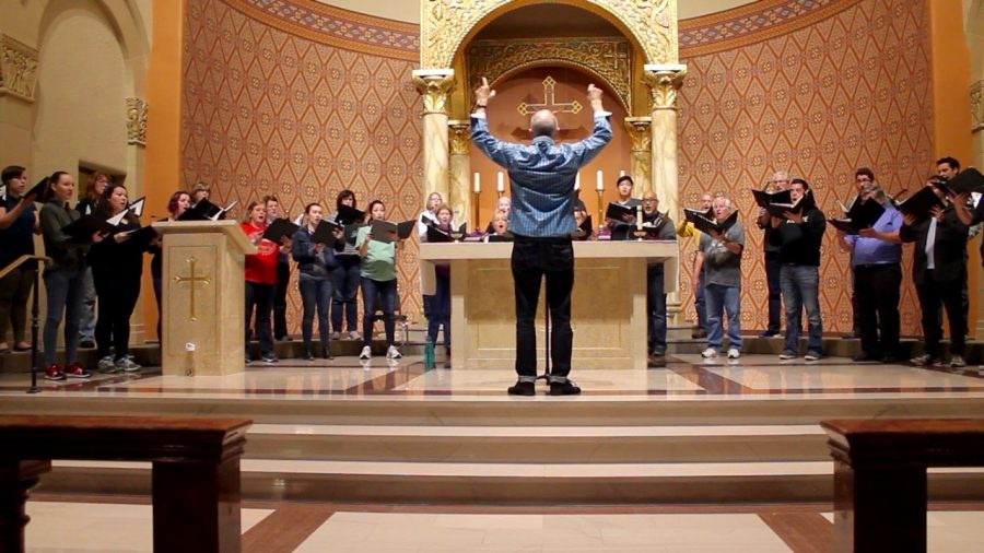 Sacramento State choral director Donald Kendrick leads the Sacred Heart Church group Schola Cantorum in a song during a rehearsal. The choir performs every Sunday at Sacred Hearts 11 a.m. mass. (Photo by Sami Soto)