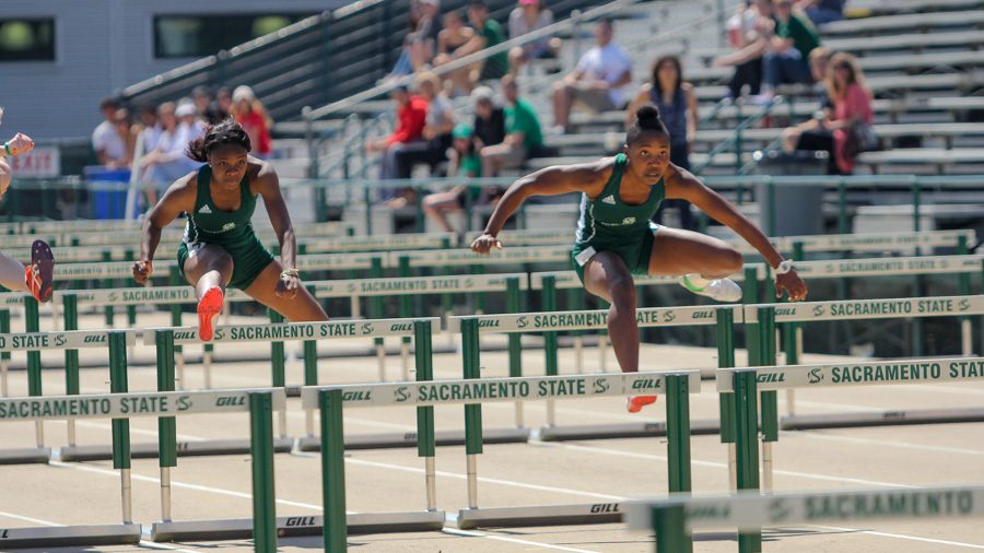 Sacramento State freshman Artearra Coffey, left, and senior Kristen Robinson, right, sprint in the womens 100-meter hurdle race in the Mondo Team Challenge April 1 at Hornet Stadium. (Photo by Andre Newell)