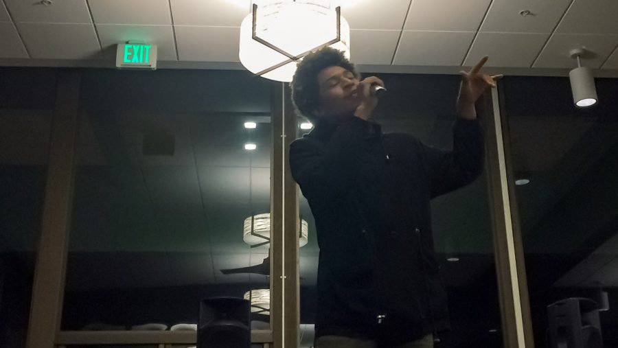 Sacramento State sophomore Kailord Low performs a poem at KSSU-AMs Poetry Slam night in the Residence Halls Dining Commons on April 7. (Photo by Myha Sanderford)