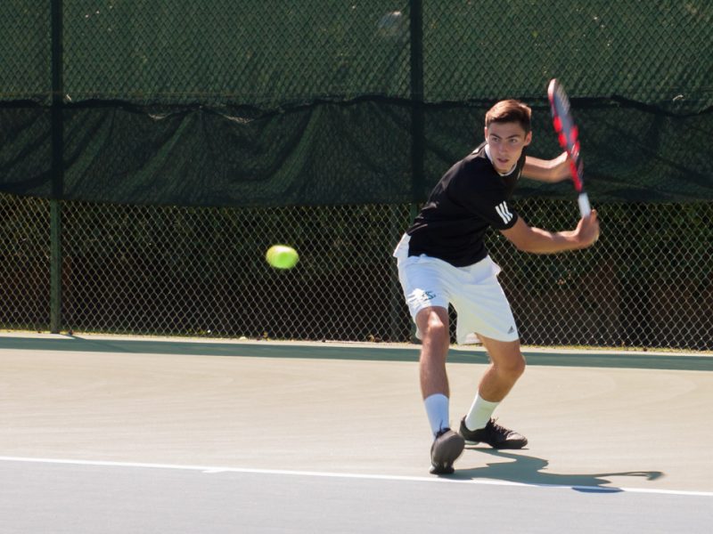 Sacramento State freshman Louis Chabut winds up to hit the ball against Northern Arizona Sunday at the Rio Del Oro Racquet Club. (Photo by Andro Palting)