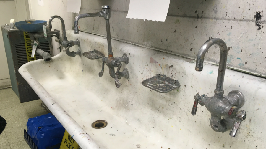 The water running through sink placed in the middle of two bathroom stalls inside the Art Sculpture Lab is contaminated with lead. (Photo by Rin Carbin)