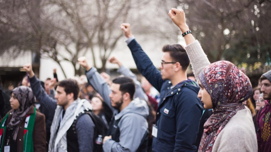 Demonstrators march through the Sacramento State campus during a #NoBanNoWall protest on Feb. 2, 2017. An estimated 300 people attended. (Photo by Nicole Fowler)