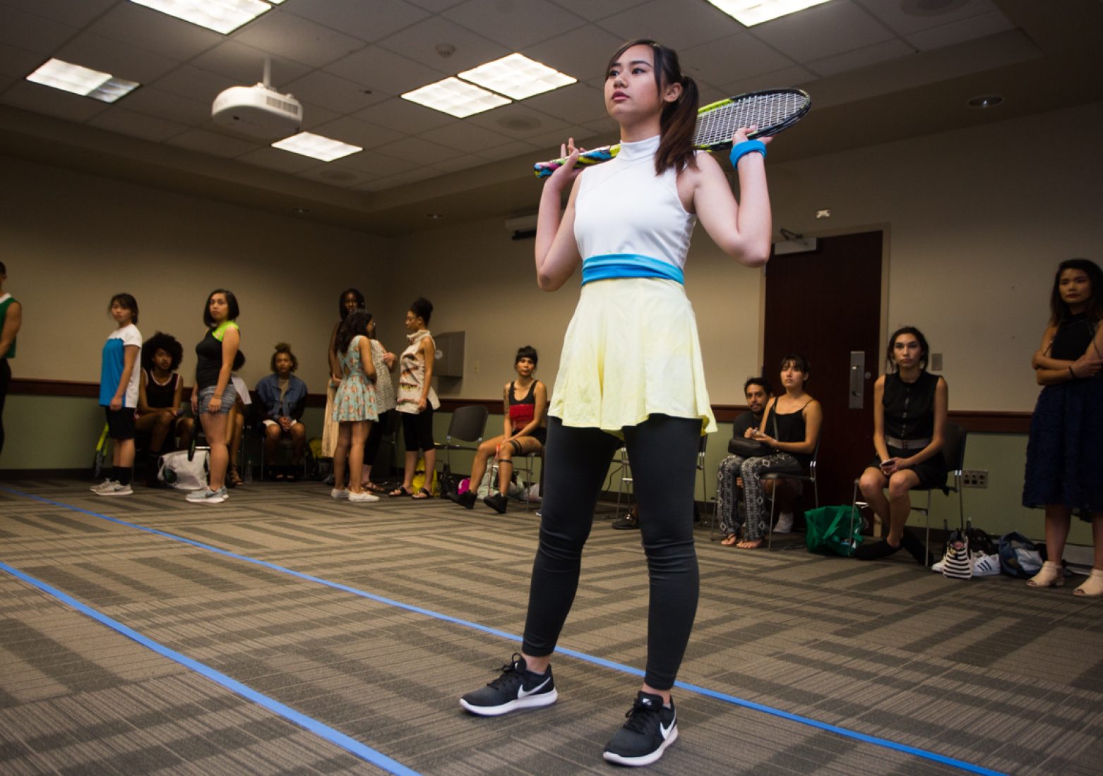 A model practices her runway walk in a Phua Lee design during rehearsal in the University Union Foothill Suite on Wednesday. Many of Lee’s models in her ‘Take the Hint’ collection carry tennis racquets on the catwalk. (Photo by Nicole Fowler)