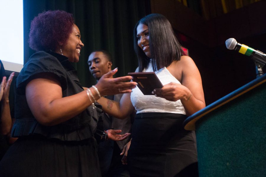 Yvonne Alexander, left, presents the Isaiah Alexander Award to Sacramento State student Chantiera Conley on July 9, at the Black & White Gala in the University Union Redwood Room. The award was given to the student who has overcome adversity and special circumstances while pursuing academics. (Photo by Nicole Fowler)