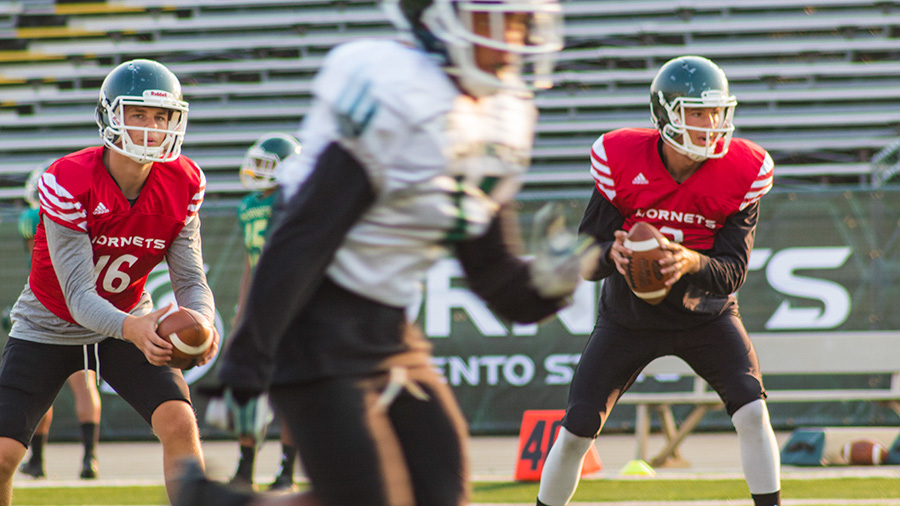 Sacramento State freshman quarterback Jack Rice, left, and senior Kolney Cassel, right, practice a drill during training camp Aug. 21 at Hornet Stadium.