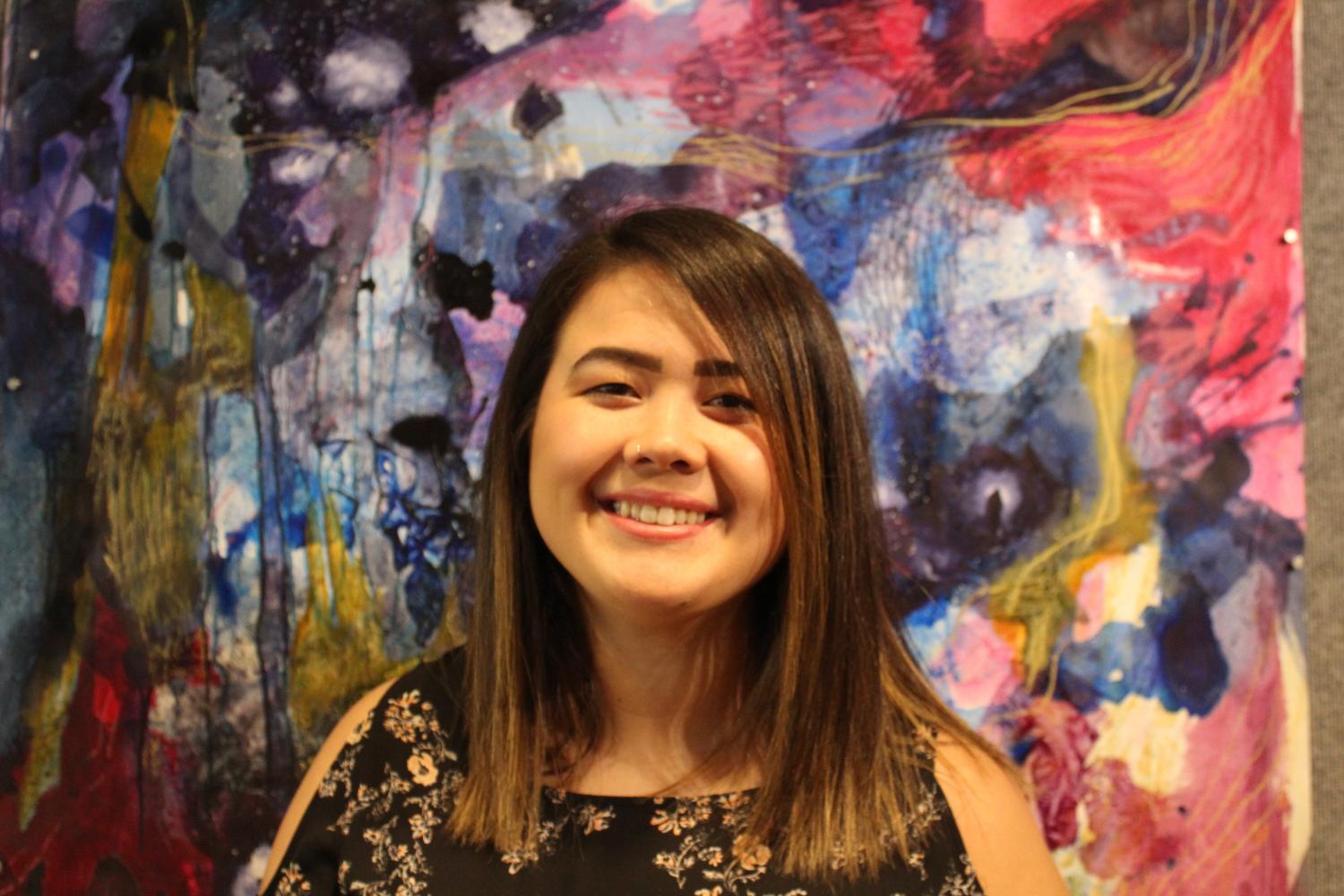 Caiti Chan stands with her work