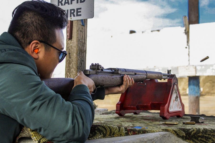 Digital Editor Vu Chau shoots a rifle at the Cordova Shooting Center on Oct. 20.