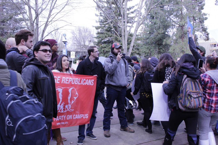 No Ban, No Wall protesters walk around Sacramento State College Republicans as they block their path during their on-campus march on Feb. 2.