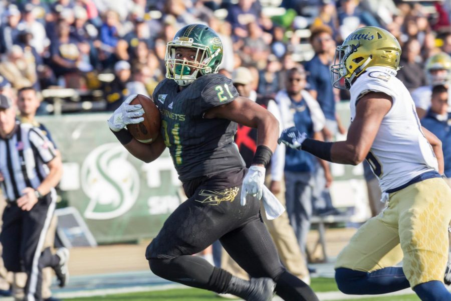 Sacramento State freshman running back BJ Perkinson sprints away from a UC Davis defender in the 64th annual Causeway Classic at Hornet Stadium on Saturday, Nov. 18, 2017. Sac State defeated the Aggies 52-47.