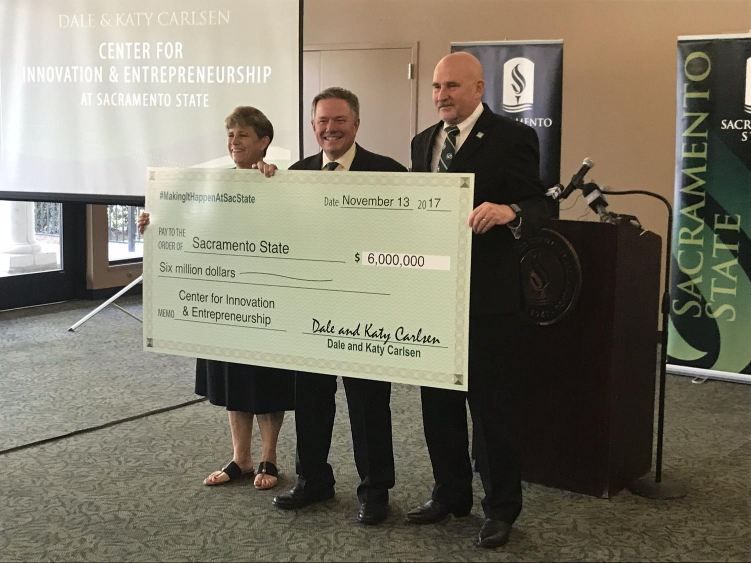 Dale and Katy Carlsen present a $6 million check to Sacramento State President Robert Nelsen in the Alumni Center on Monday. The check was the largest private donation in the University's history.