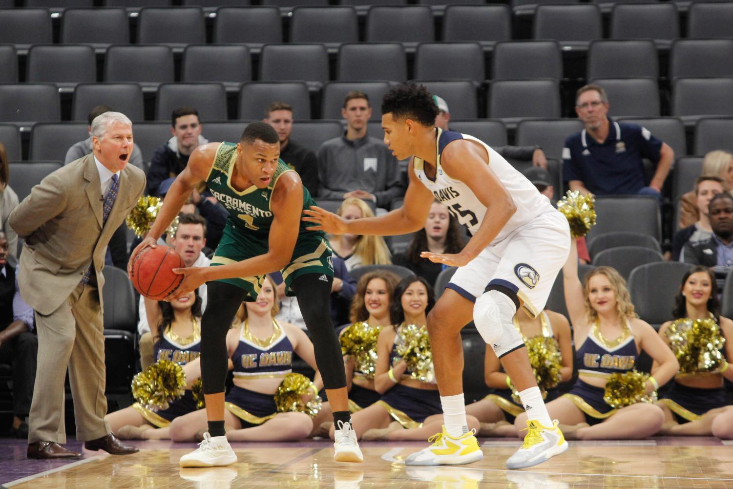 Sacramento State senior forward Justin Strings protects the ball against UC Davis junior forward AJ John Tuesday, Nov. 21 at the Golden 1 Center. Strings posted 17 points, 12 rebounds and 10 turnovers in a 64-47 loss against the Aggies.